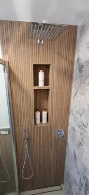 a bathroom with three toilets on a wooden wall at Manzoni 99 in Merano