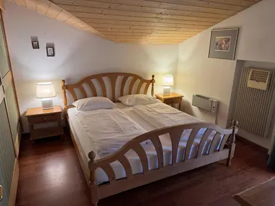 a bedroom with a large bed with two night stands at Sport Hotel Astoria Residence in La Villa