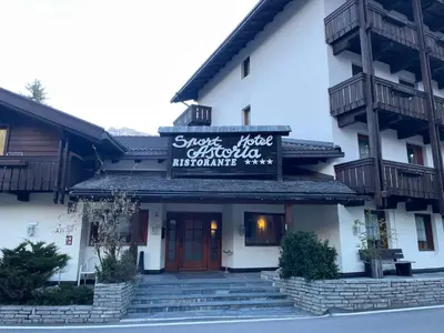 a building with a sign on the front of it at Sport Hotel Astoria Residence in La Villa