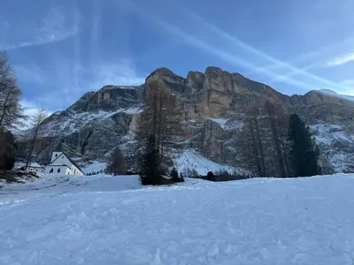 a house in front of a mountain in the snow at Sport Hotel Astoria Residence in La Villa