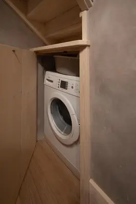 a washer and dryer in a small room at Casa Funivia, immersa nel verde e vicina al centro di Cortina in Cortina dʼAmpezzo