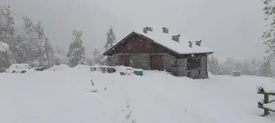 a house covered in snow in front at Chalet Al Maso Val Calamento in Telve