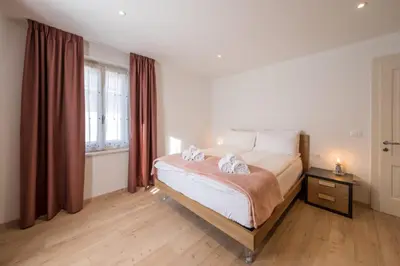 a bedroom with a bed with two towels on it at Appartamento Dolomiti Dream 1 in Falcade