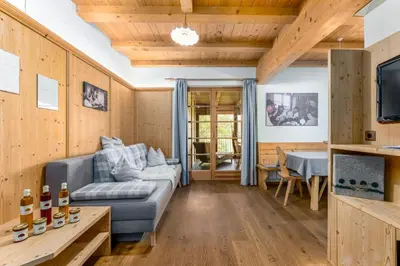 a living room with a couch and a table at Froetscherhof, Urlaub auf dem Bio-Bauernhof in Brixen, Appartments, Sauna und BrixenCard in Bressanone