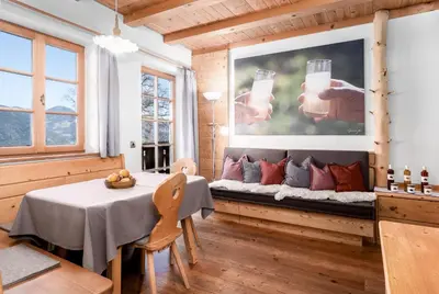 a dining room with a couch and a table at Froetscherhof, Urlaub auf dem Bio-Bauernhof in Brixen, Appartments, Sauna und BrixenCard in Bressanone