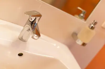 a bathroom with a sink with a faucet at Speckstube Eggerhof in Braies