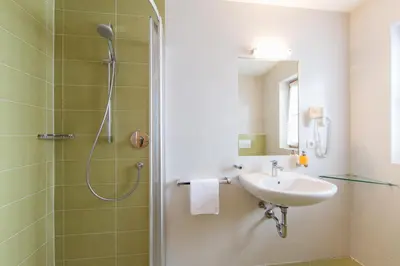a bathroom with a shower and a sink at Speckstube Eggerhof in Braies