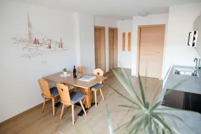 a dining room with a wooden table and chairs at Fritzenhof in Termeno