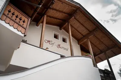a building with a sign on the side of it at Hof Zerund in Castelrotto