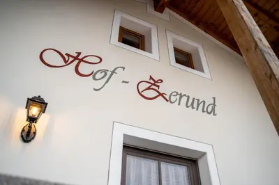 a sign on the side of a building with windows at Hof Zerund in Castelrotto