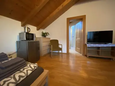 a living room with a bed and a flat screen tv at FaWa Apartments 