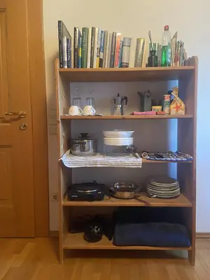 a book shelf with plates and dishes on it at FaWa Apartments 