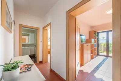 a hallway with a door leading to a kitchen and a living room at Apartments Villa Vardia in Caldaro