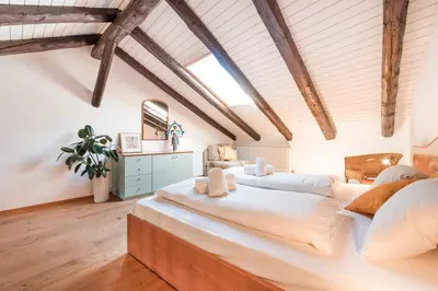 a large bedroom with two beds in a attic at Apartments Ansitz Wieshof in Castelvecchio