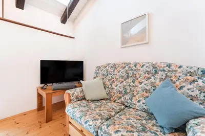 a living room with a couch and a tv at Apartments Ansitz Wieshof in Castelvecchio