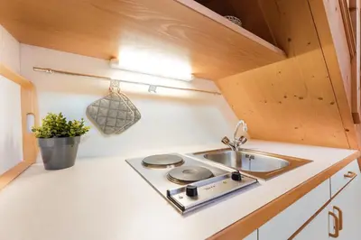 a small kitchen with a sink and a stove at Apartments Ansitz Wieshof in Castelvecchio