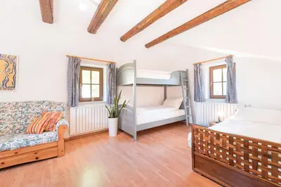a bedroom with two bunk beds and a couch at Apartments Ansitz Wieshof in Castelvecchio