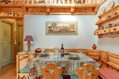 a dining room with a table and chairs at Private Veranda - Tiroler Chalet - Near Ski Slopes & Dolomites in Carano