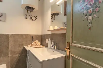a bathroom with a sink and a shower at Private Veranda - Tiroler Chalet - Near Ski Slopes & Dolomites in Carano