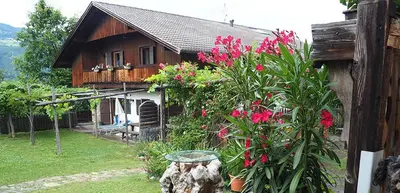 a house with pink flowers in front of it at Tommele Hof in Volser Aicha
