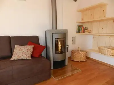 a living room with a couch and a fireplace at Laerchhof in Collalbo