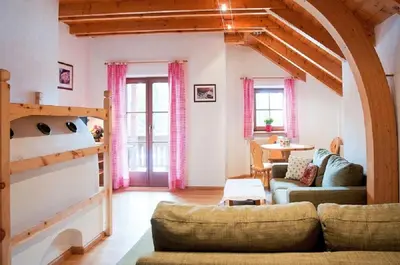 a living room with a couch and a staircase at Laerchhof in Collalbo