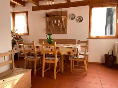 a dining room with a table and chairs at Eco Chalet Nonno Silvano in Bedollo