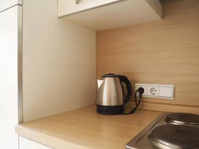 a tea kettle sitting on a counter in a kitchen at Saint Martin Guest House in Cornaiano