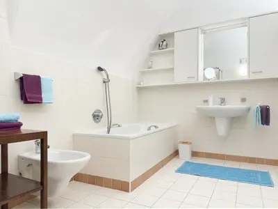 a white bathroom with a tub and a sink at apartment beletage in San Lorenzo di Sebato