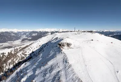 a snow covered mountain with a ski lodge on top of it at apartment beletage in San Lorenzo di Sebato