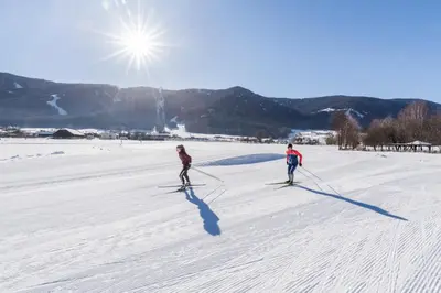 two people on skis in the snow at apartment beletage in San Lorenzo di Sebato