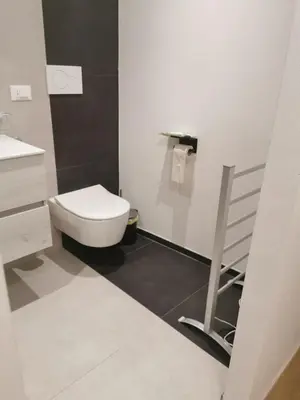 a white bathroom with a toilet and a sink at Casa della Lavanda in Sarnonico