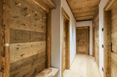 a hallway with wood paneling and a wooden wall at Chalet Ronco - Dolomiti Skyline in Cortina dʼAmpezzo