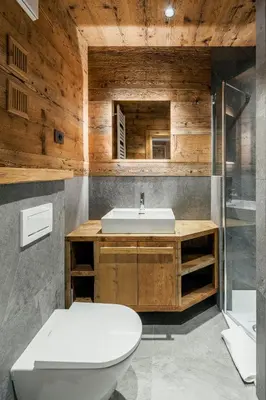 a bathroom with a toilet and a sink at Chalet Ronco - Dolomiti Skyline in Cortina dʼAmpezzo