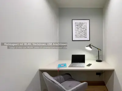 a desk with a laptop and a chair in a room at Apartments LIANA in Postal