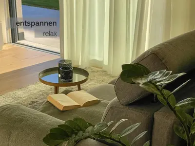 a living room with a couch and a table at Apartments LIANA in Postal