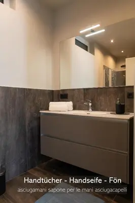 a bathroom with a sink and a mirror at Apartments LIANA in Postal