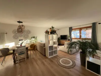 a living room with a table and a couch at Casa Carlotta Tesero-Relax and view in Tesero