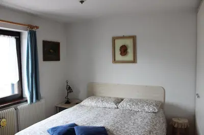a bedroom with a bed and a window at Suite Marco nice apartment in Cavalese with View in Cavalese