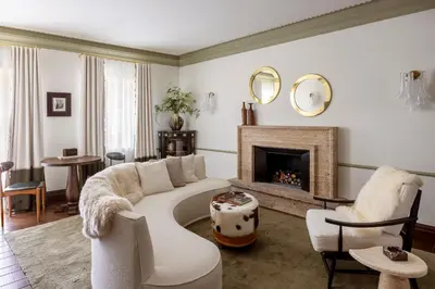 a living room with a couch and a fireplace at Ancora Cortina - The Leading Hotels of the World in Cortina dʼAmpezzo