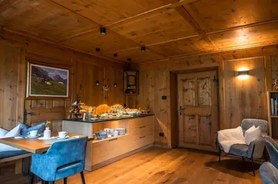 a kitchen with wooden walls and a table and chairs at Sule Hof Agriturismo in Ortisei