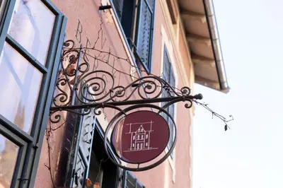 a sign hanging on the side of a building at Villa Bergmann Suites Meran in Merano