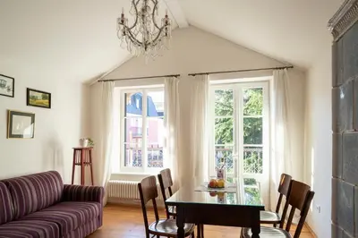 a living room with a table and a couch at Villa Bergmann Suites Meran in Merano