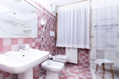 a bathroom with a white sink and a toilet at Chalet Stadio in Cortina dʼAmpezzo