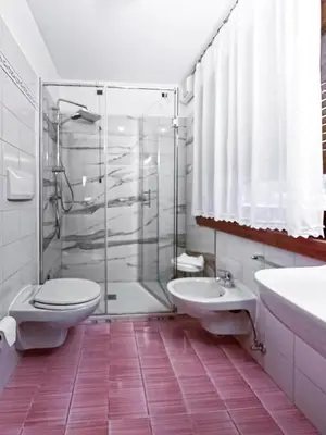 a bathroom with a shower and a toilet and a sink at Chalet Stadio in Cortina dʼAmpezzo