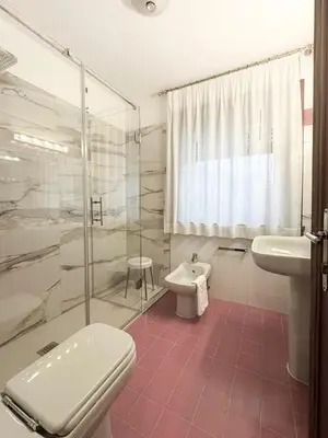 a bathroom with a toilet and a shower and a sink at Chalet Stadio in Cortina dʼAmpezzo