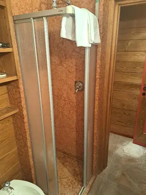 a shower with a glass door in a bathroom at Comodo e luminoso, splendida vista su Cortina in Cortina dʼAmpezzo