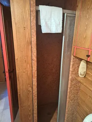 a bathroom with a towel hanging on a door at Comodo e luminoso, splendida vista su Cortina in Cortina dʼAmpezzo