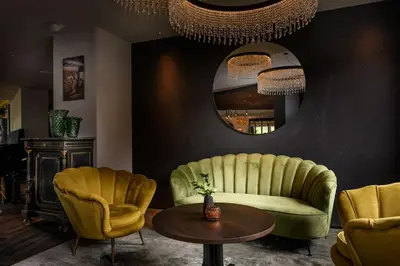 a living room with a couch and chairs and a table at Tirolensis - Luxury All Inclusive in Tesimo