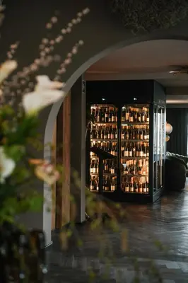 a refrigerator filled with lots of bottles of wine at Tirolensis - Luxury All Inclusive in Tesimo